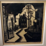 Linoleum block print
Card in back reads "Striking Block Print by Lenski. Lenski, Lois. Linoleum Block Print: The Crooked Street. This is a striking limited edition linoleum block print signed by Lenski. It is a detailed black and white scene of a crooked rural street with houses, picket fences and people. Titled in pencil by Lenski The Crooked Street. The image measures 6" square with a thick black border. Although not dated, this was done early in her career most likely in the 1920's. Written on the back in Lenski's hand is her name and address in Pelham Manor, New York. Really wonderful. (#34587)."
Gift of Guy and Carol Wolfenbarger
16 1/4" x 16" (frame);
6" x 6" (image) The Crooked Street (Lois Lenski)